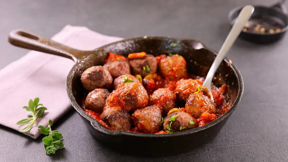 meatballs in a frying pan kept on the kitchen counter